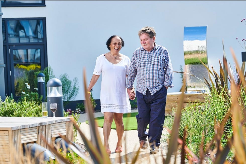 older couple walking through outdoor space