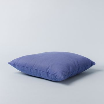 a blue pillow on a white surface, camille gharbi