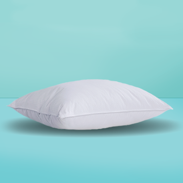 a white pillow on a turquoise background