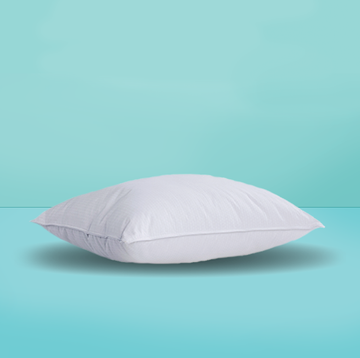 a white pillow on a turquoise background