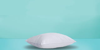 a white pillow on a turquoise background