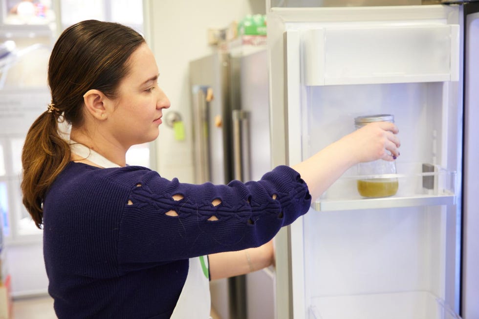 Person retrieving a jar from a refrigerator