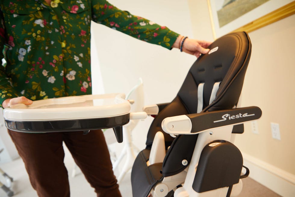a member of the good housekeeping institute tests a high chair tray