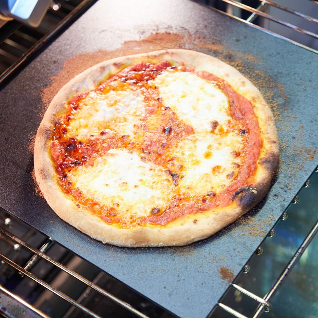 pizza on pizza stone in oven