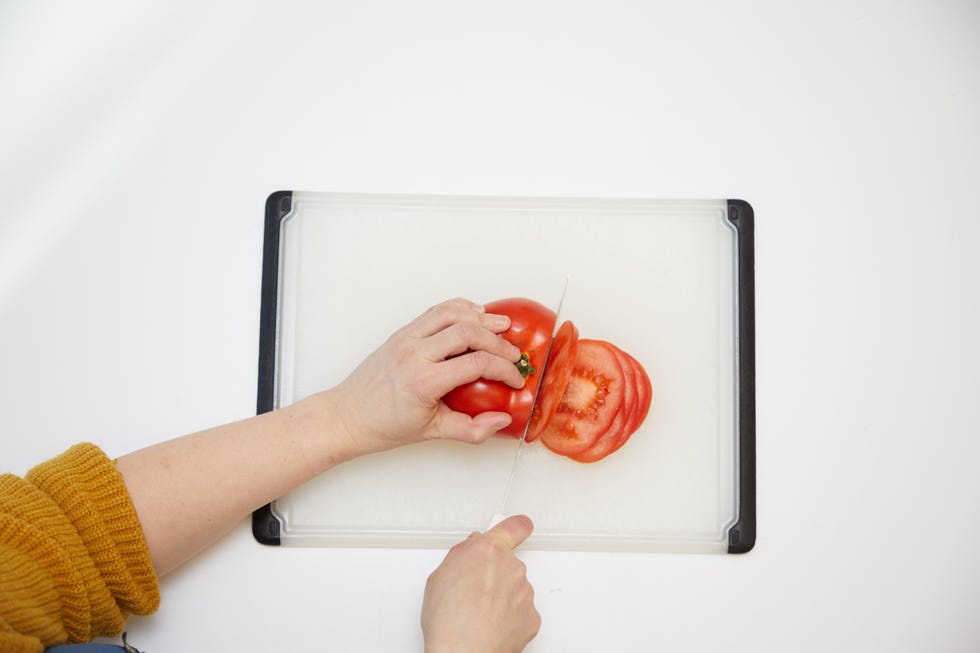 testing a fillet knife by slicing a tomato