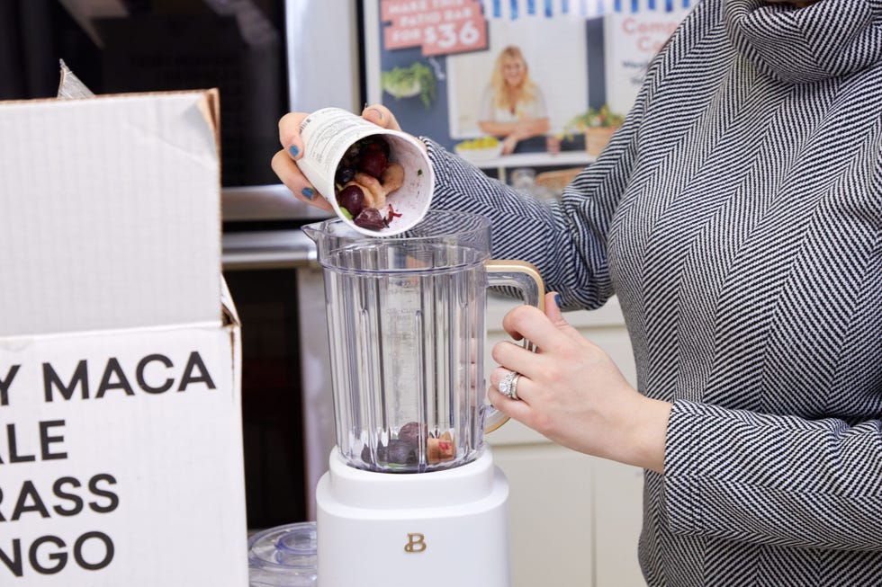 Ingredients being added to a blender for smoothie preparation