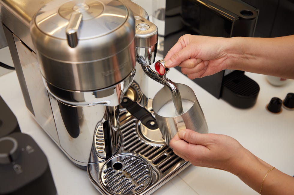 nespresso frothing wand making foam in a metal carafe