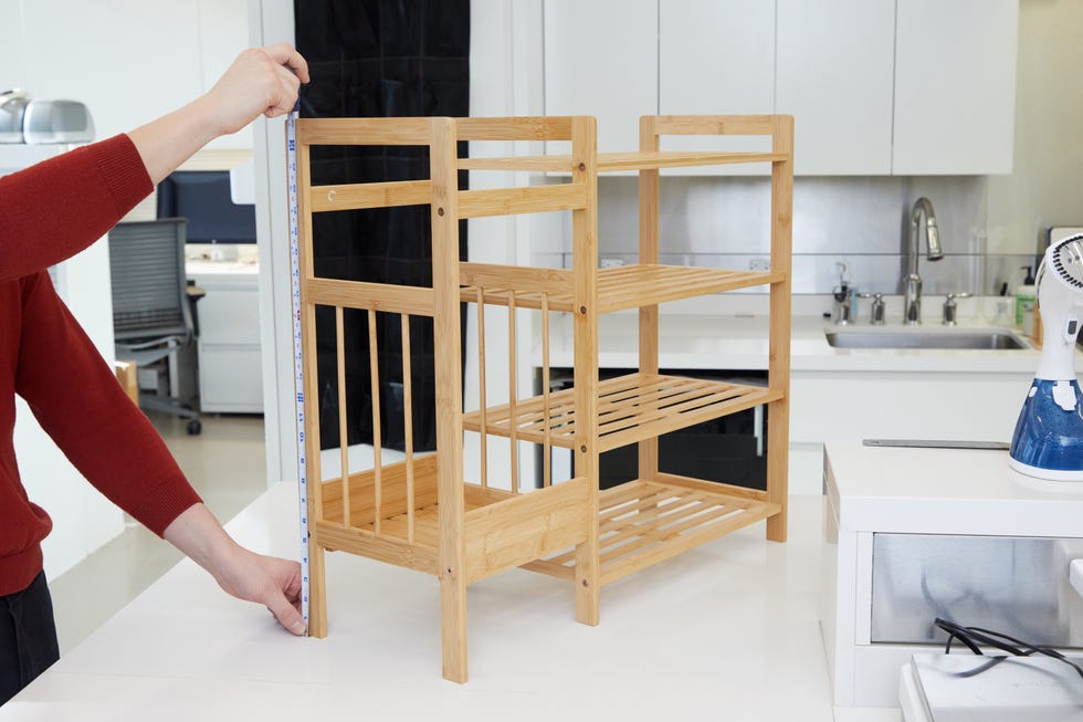 best shoe racks person measuring the size of a shoe rack