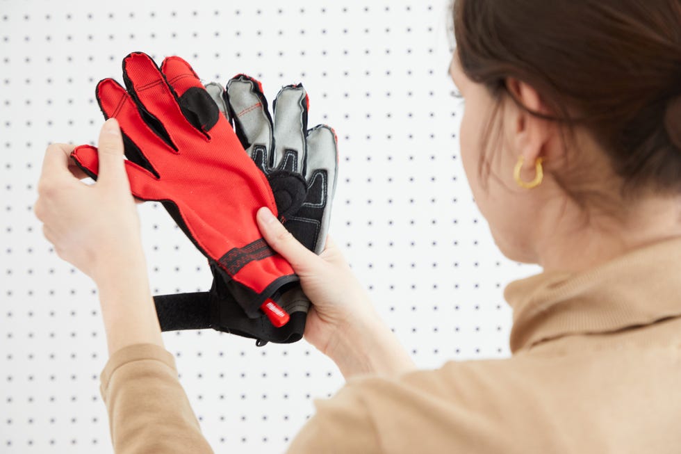 two types of gloves being held for comparison