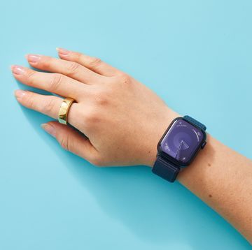 a person's hand with an apple watch and an oura ring on