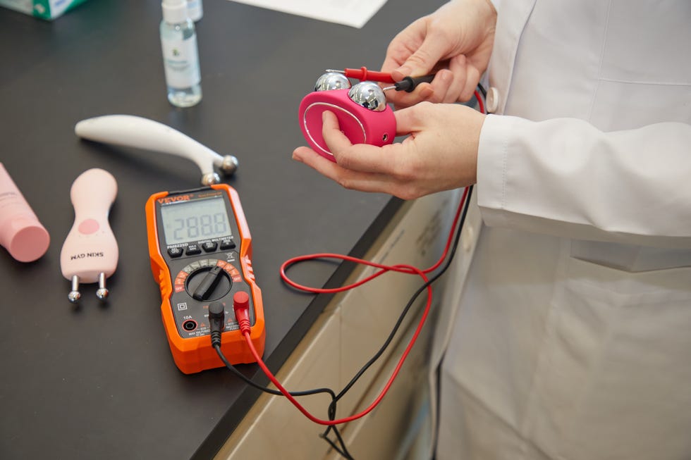 a good housekeeping institute beauty lab scientist testing at home microcurrent devices