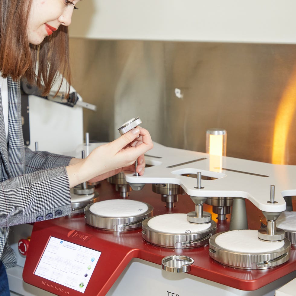 how we test pilling on sheets an analyst observes a fabric swatch that has undergone a thousand rubs against a larger fabric sample for signs of pilling
