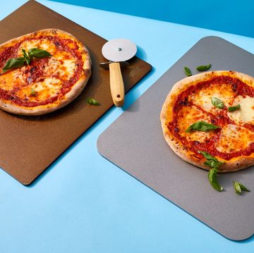 two pizza stones and steels with pizzas