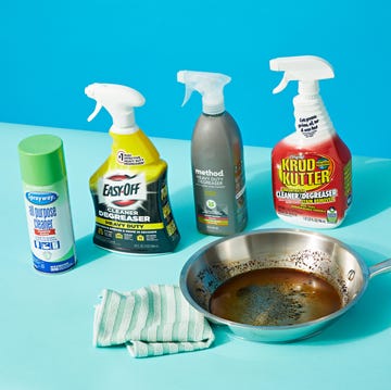 a bowl of food and bottles of cleaning products on a blue surface