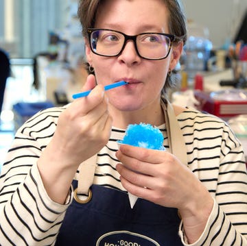 best ice shaving machines woman with glasses and an apron tasting a blue snow cone