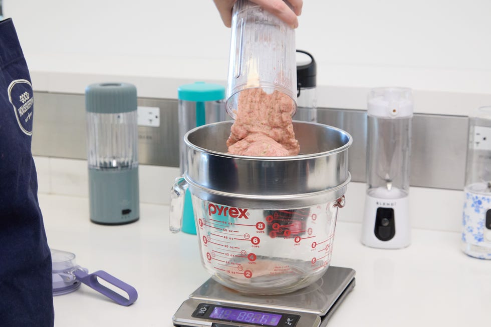 pouring smoothie contents into sieve