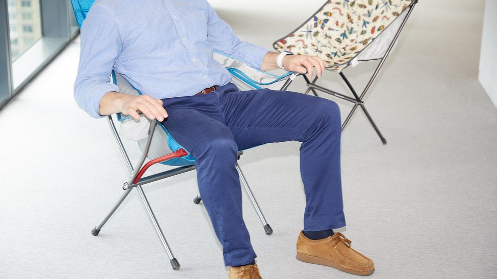 a person sitting in a camping chair to evaluate its comfort