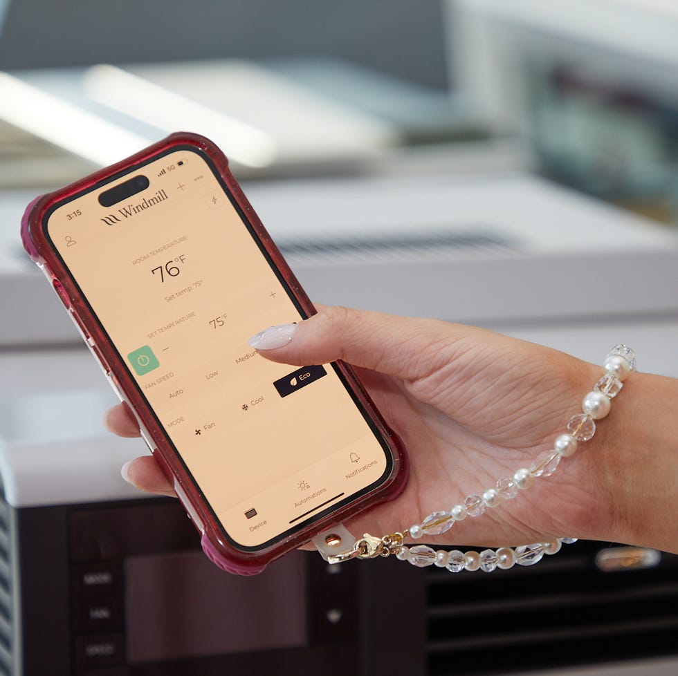 window ac testing a person holding a phone