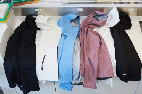 raincoats laid out on a countertop for evaluation