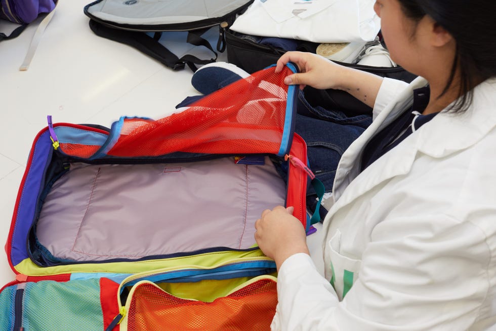 an analyst packs a travel backpack