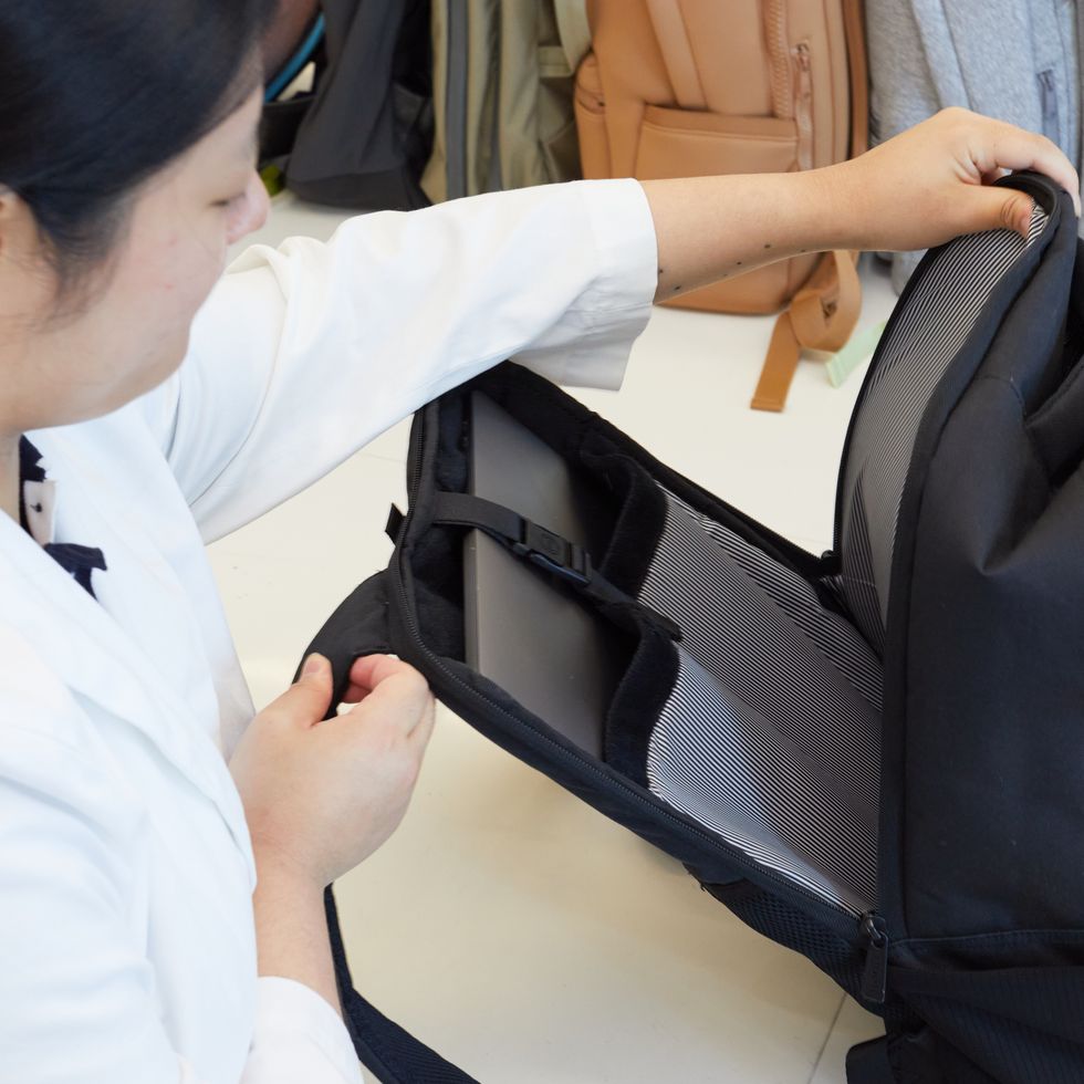an unzipped black backpack from herschel with a separate laptop component