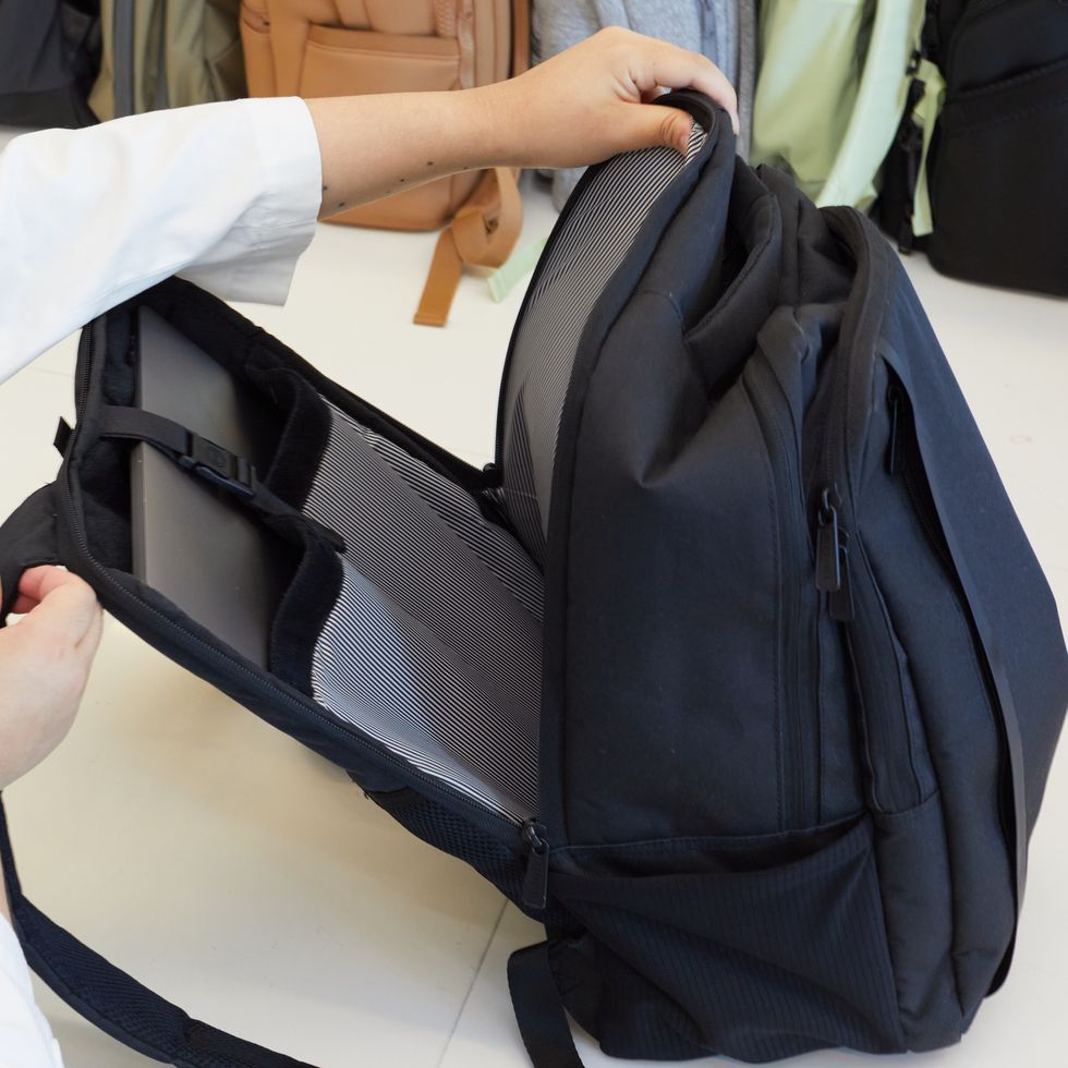 an unzipped black backpack from herschel with a separate laptop component