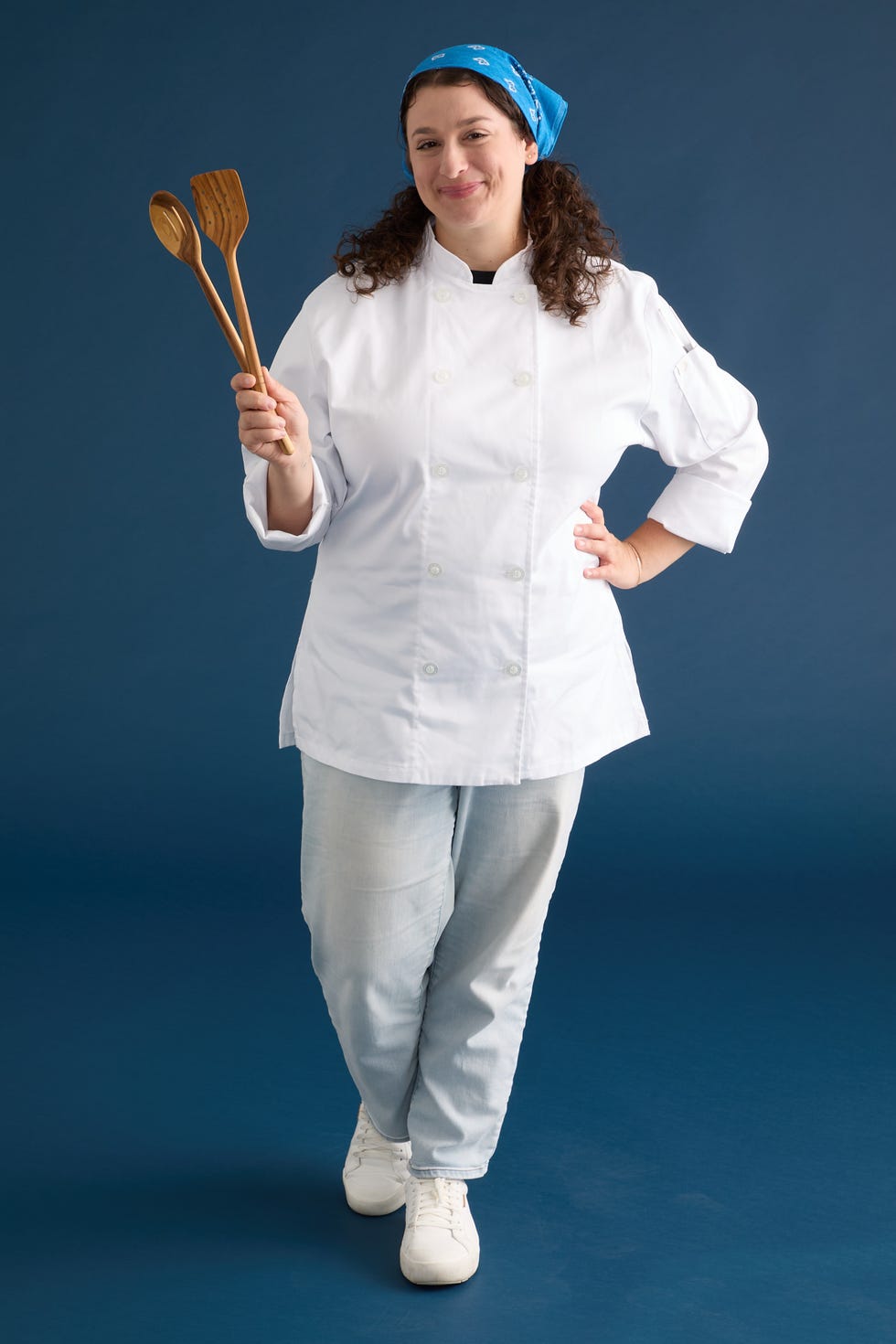 chef holding wooden spoons