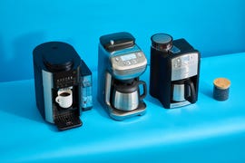 three coffee makers with grinders on a blue background