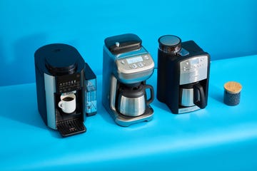 three coffee makers with grinders on a blue background