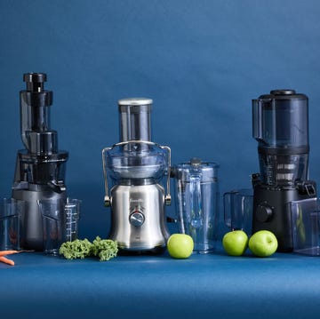 best juicers three juicers side by side with carrots, kale and apples on the counter
