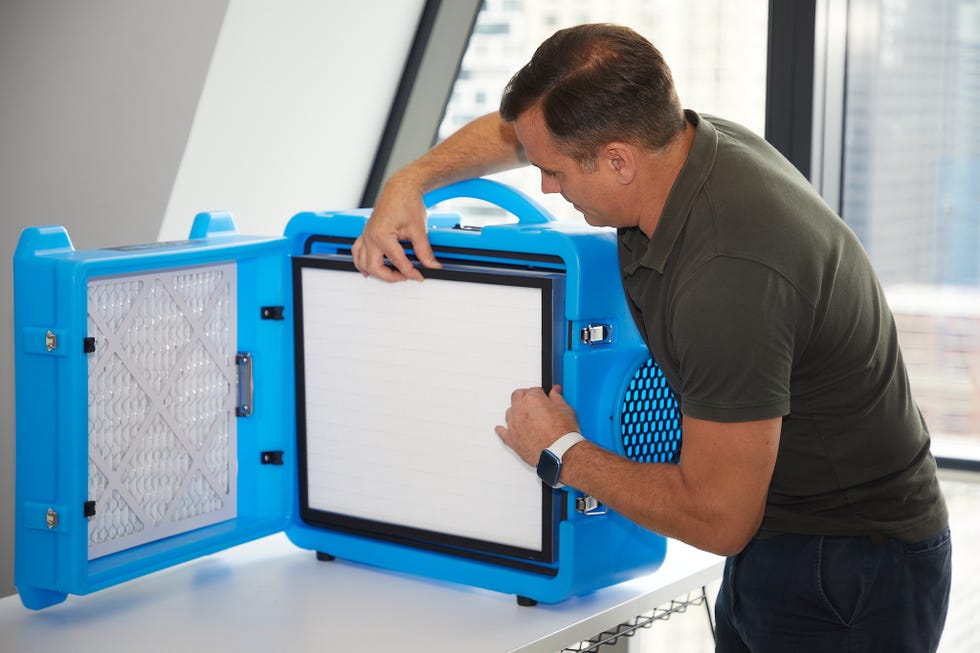air purifier testing an expert examines the filter insider and air purifier during testing
