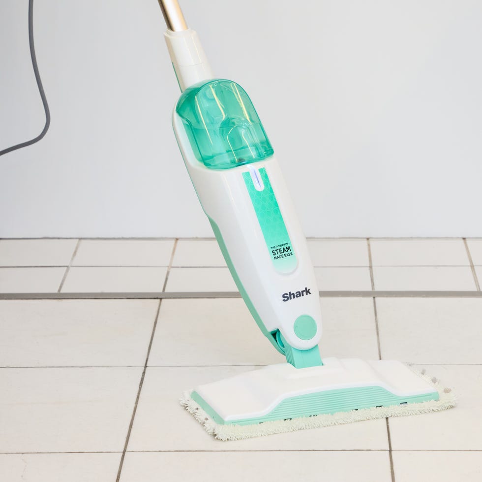 Best Steam Mops: Shark S1000 Steam Mop white and green steam mop on a white tiled floor
