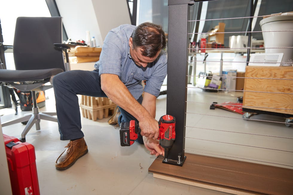 a tester drills bolts into a piece of lumber