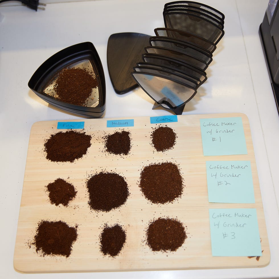 best coffee grinder three sets of different size coffee grounds on a board sitting next to a coffee sifter