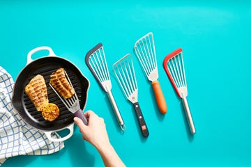 hand lifting grilled fish from a pan next to our top performers