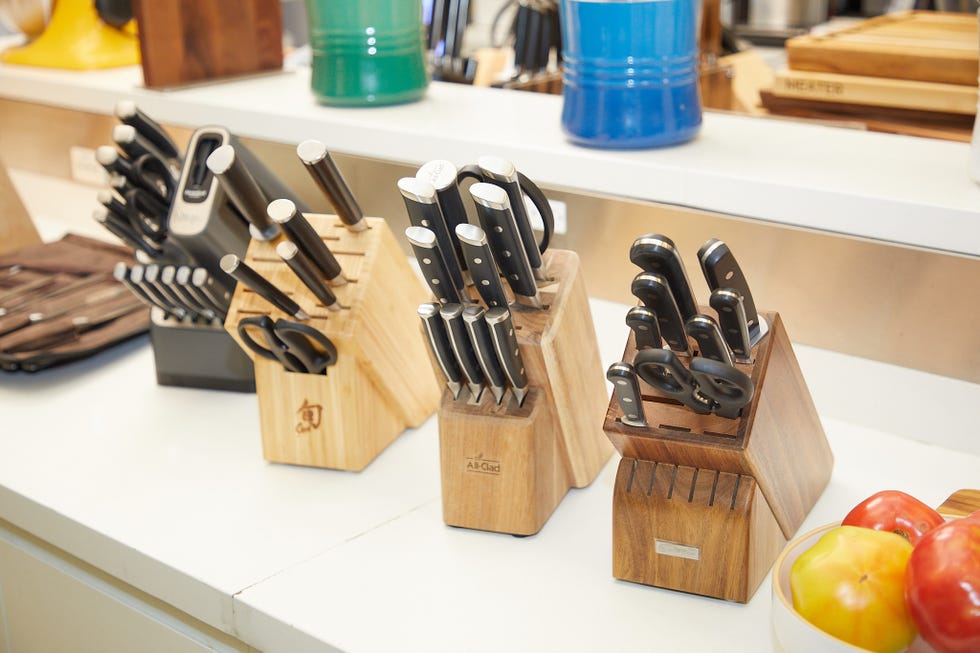 Knife blocks containing a variety of kitchen knives and scissors