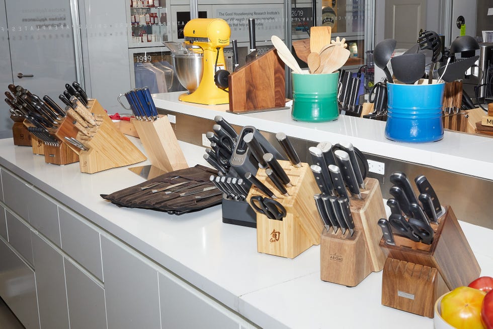 Display of various knives and kitchen utensils on a countertop