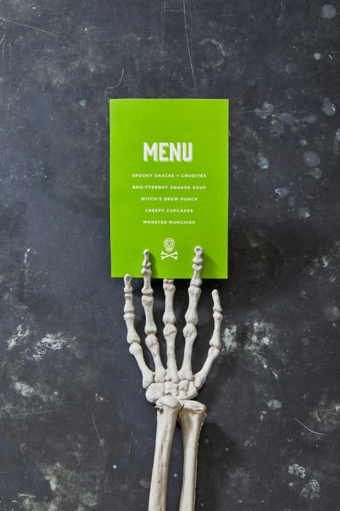 halloween party ideas, skeleton hand holding a green menu
