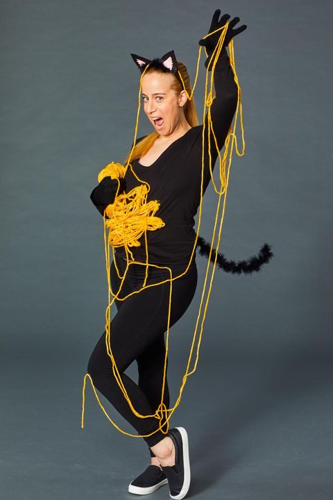 rachel rothman dresses as a black cat with a ball of yarn "bump" as part of a pregnant halloween costume