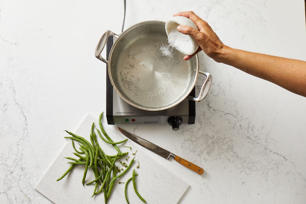 salting a pot of water for blanching green beans