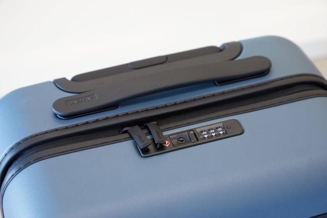 hardshell suitcase with a combination lock and dual handles