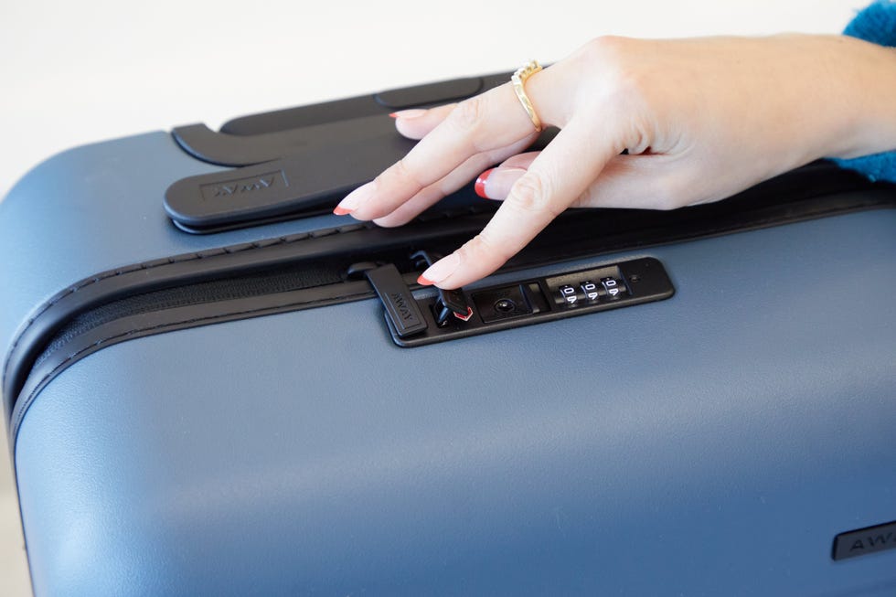 a good housekeeping analyst testing away luggage's lock, good housekeeping's away luggage review