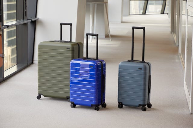 three away suitcases in a hallway, good housekeeping's away luggage review