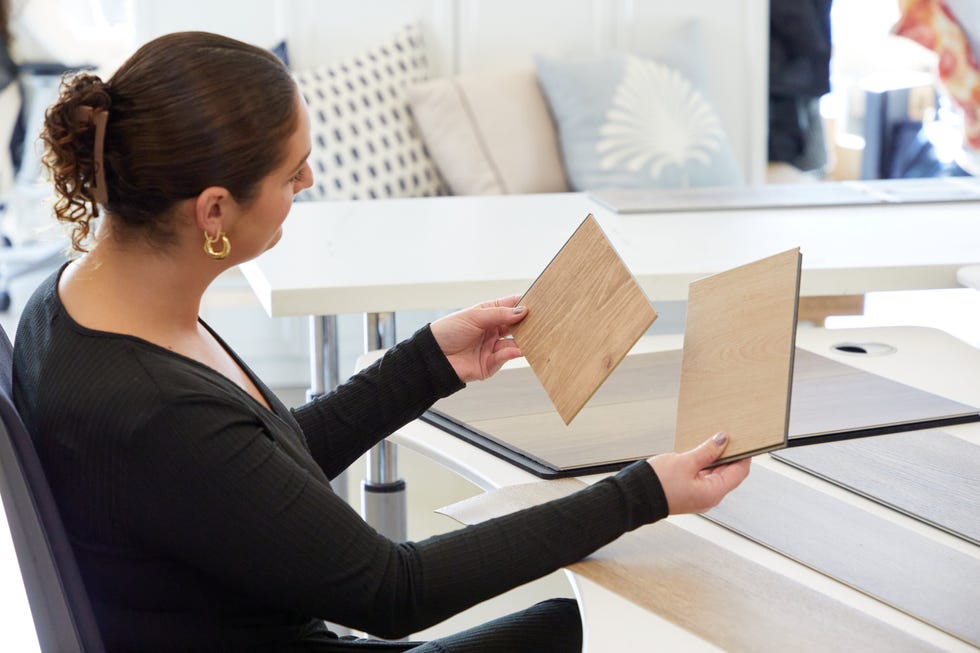 a design expert evaluates color and pattern of vinyl floor samples