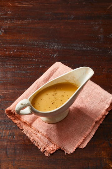 serving boat filled with make ahead gravy ontop of a pink folded napkin