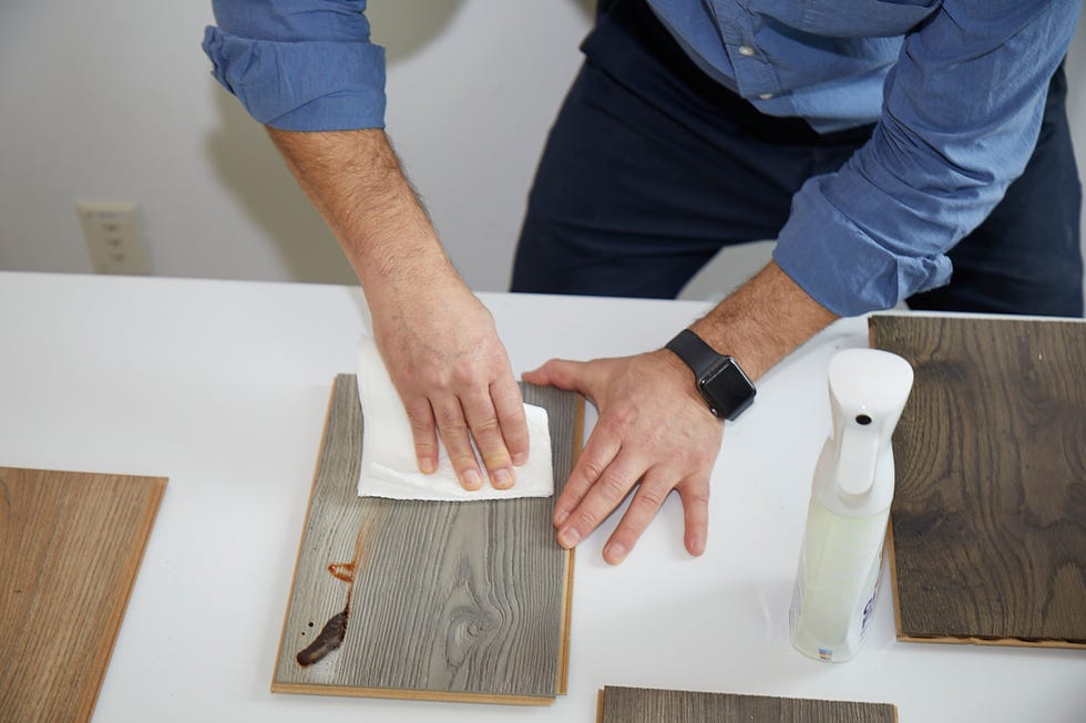 a good housekeeping expert tests stain resistance of laminate flooring by seeing how easily a range of stains are removed with a towel and cleanser