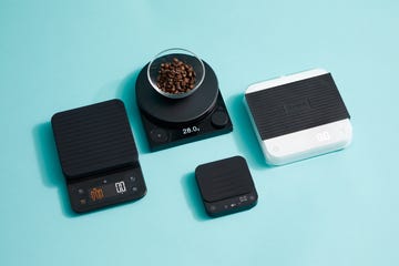 four coffee scales on a blue background with a bowl of coffee on one scale