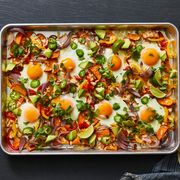 sheet pan breakfast fajitas topped with sunny side up eggs