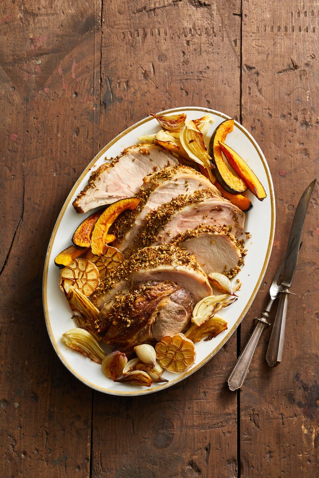 roasted pork loin with vegetables on a platter
