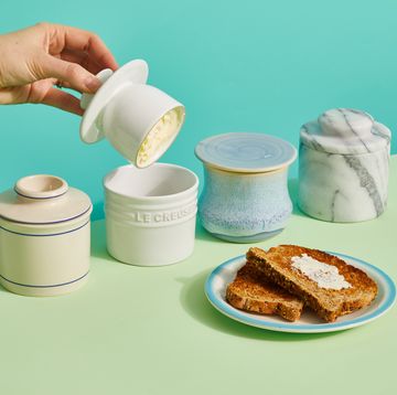 four butter crocks with toast with butter